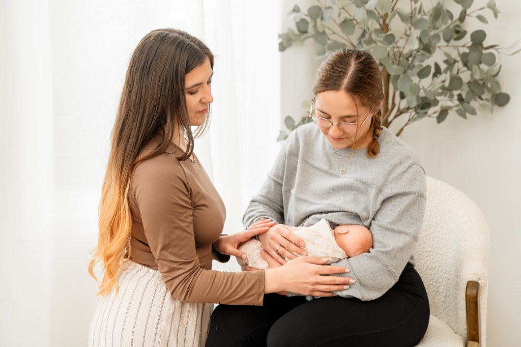 Doula helping new mom with chestfeeding