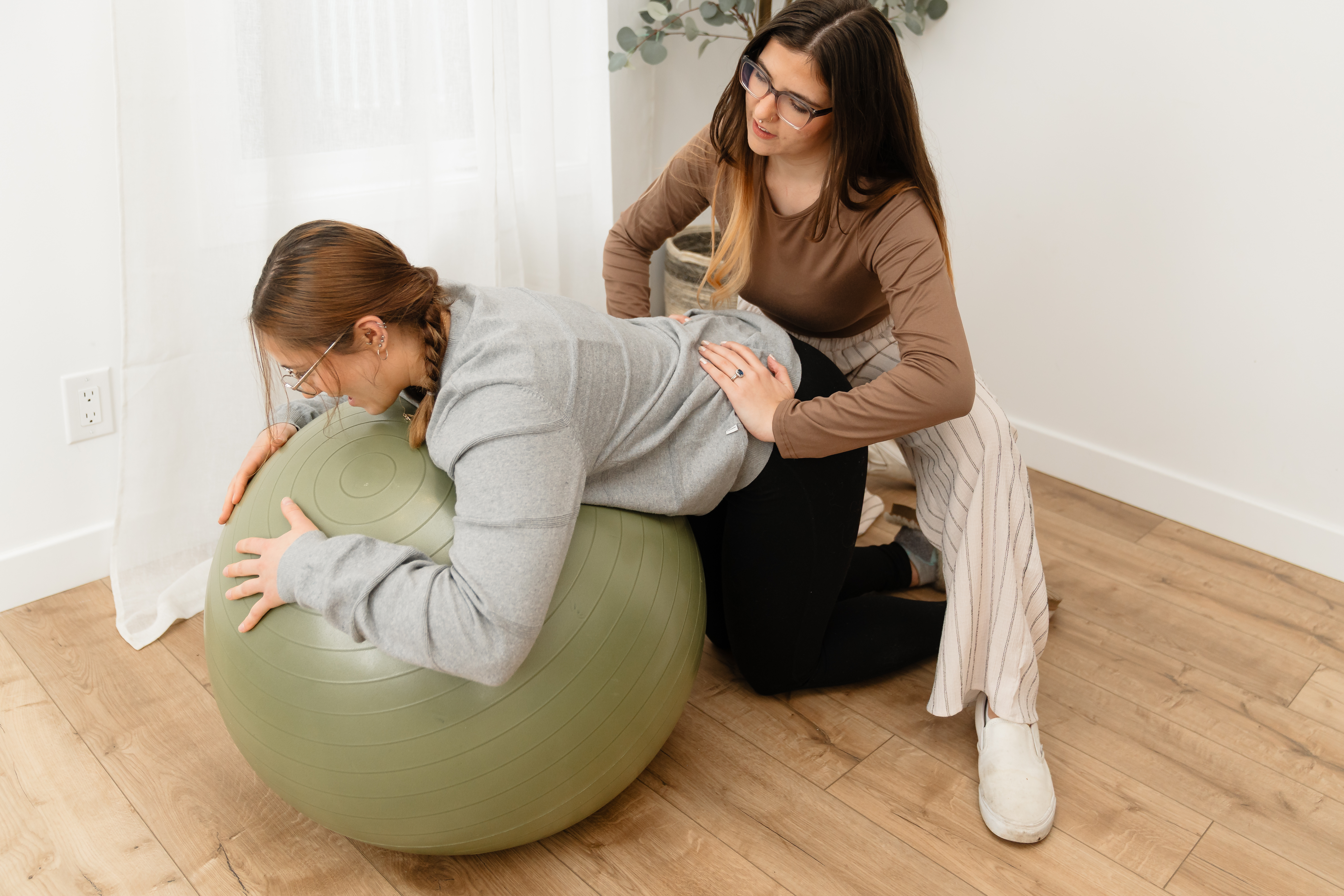 Doula doing a double hip squeeze on client while in labor.