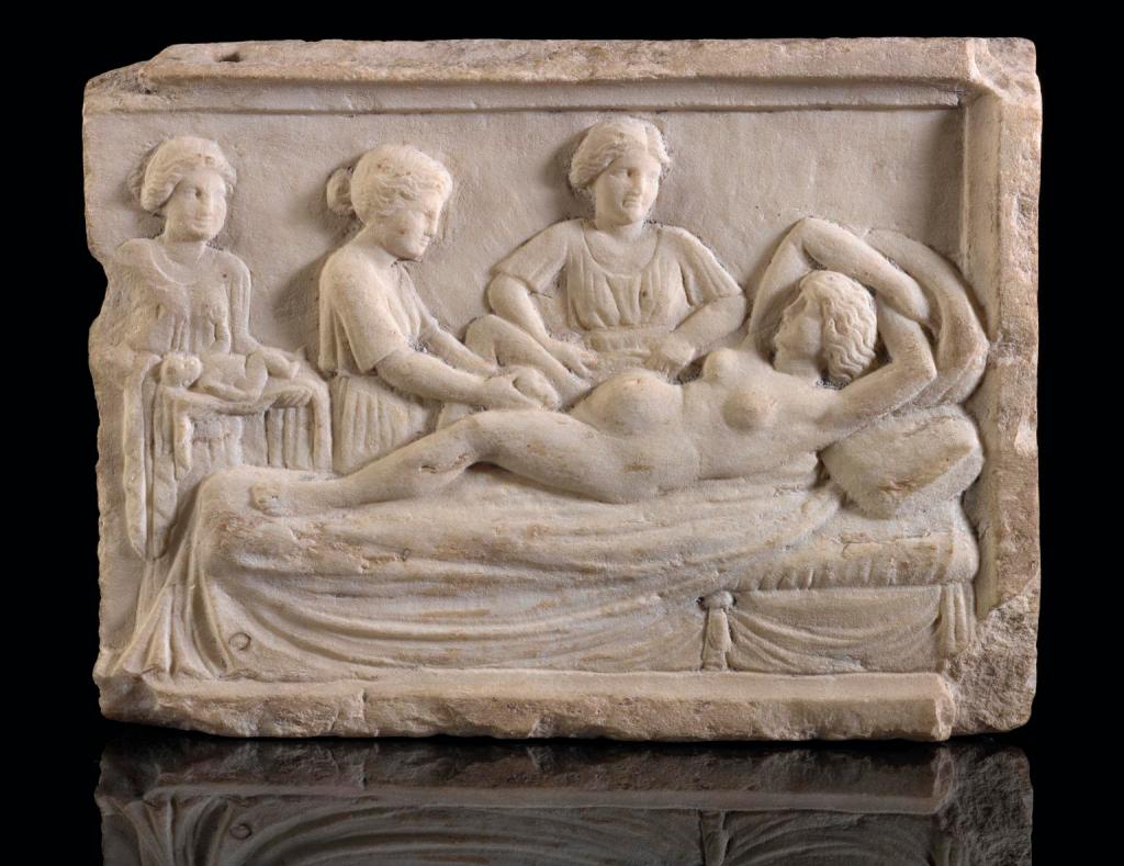 Roman marble plaque showing a birthing scene.
